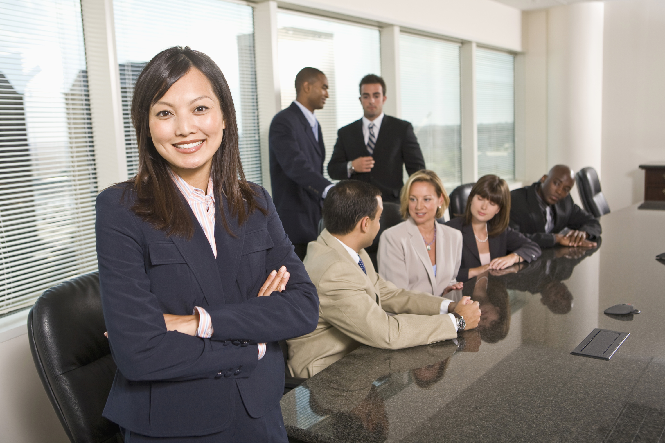 asian woman at conference table